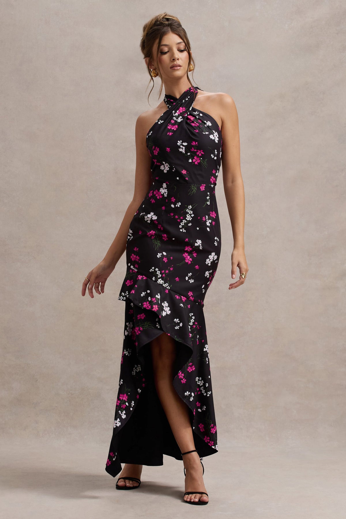 Melodia | Schwarzes Maxikleid aus Satin mit Gänseblümchenmuster, Rüschen und Halterneck-Ausschnitt.
